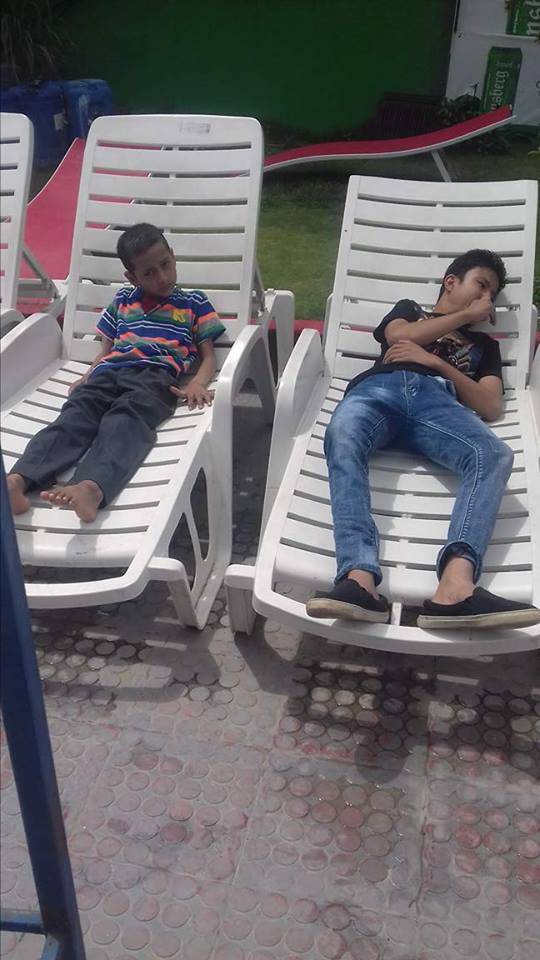 Two students lounging on the beds