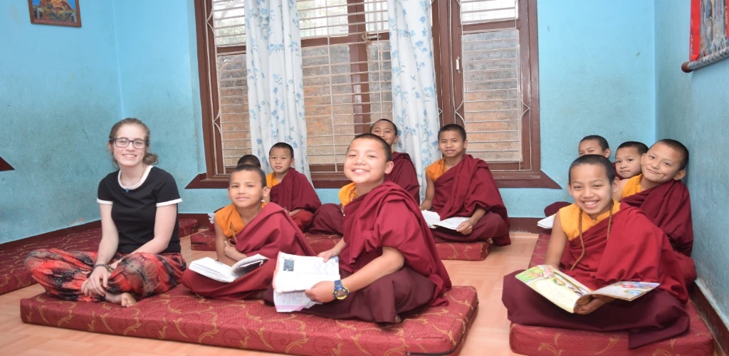 Volunteer from netherlands taking a picture at local monastery in nepal