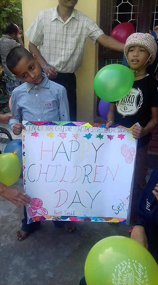 Children with a children's day sign