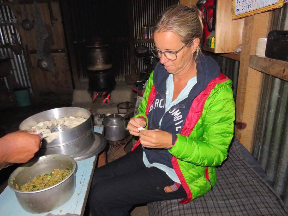 Helping to cook local momo 