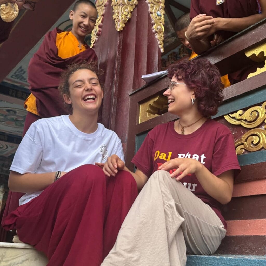 Young female volunteer teaching at Buddhist monastery in Kathmandu Nepal