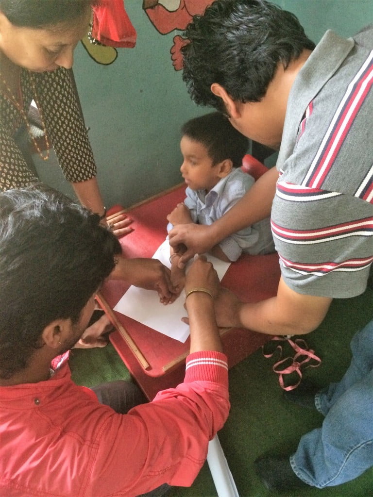Working with other therapists to take arm measurements 